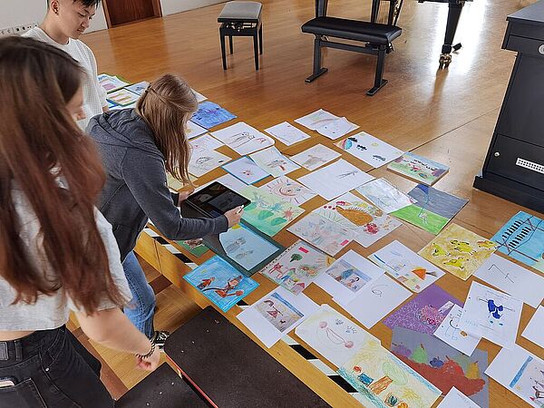 Foto: Studierende analysieren ihre eigenen Kinderzeichnungen